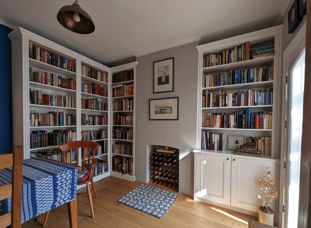 bespoke book shelves and built in cupboards in a dining room