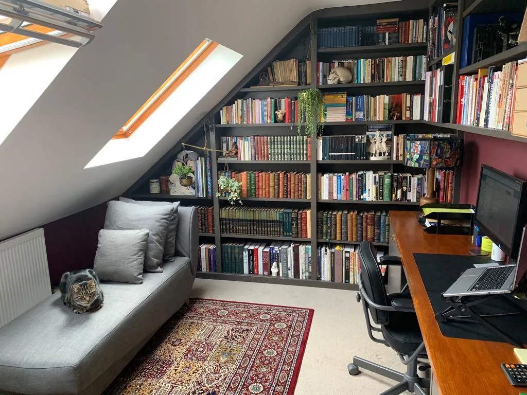 Built in alcove book shelves in a loft room