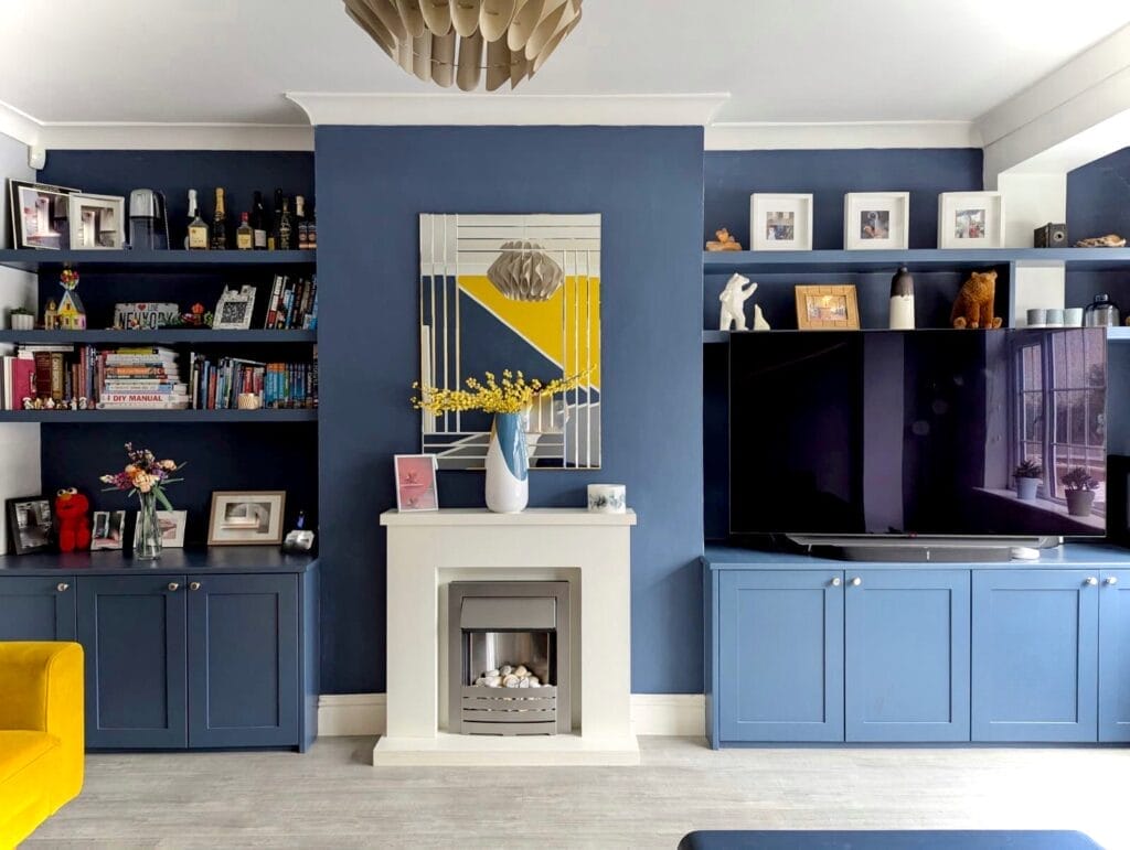 floating shelves either side of a fireplace with built in cabinets and TV stand